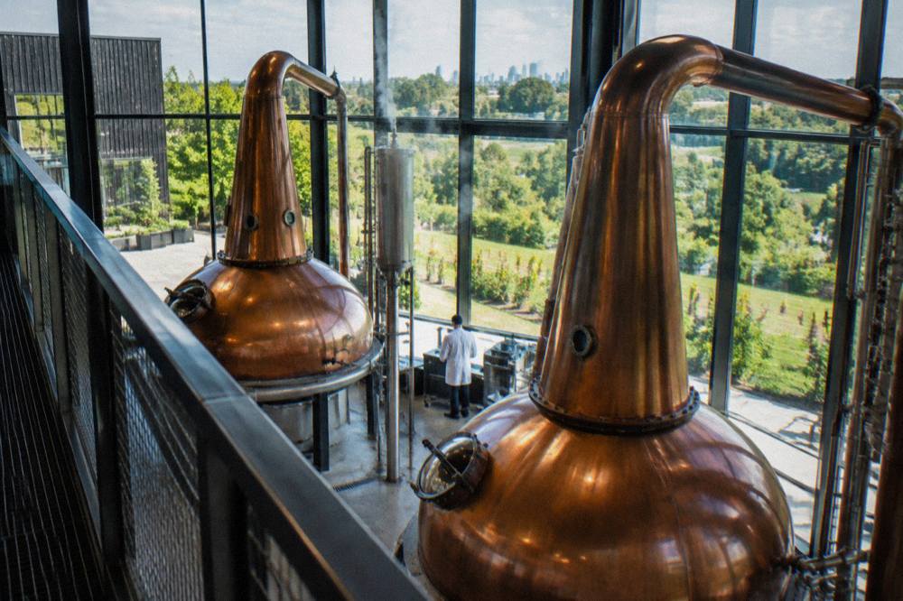 Copper pot stills inside a bourbon distillery still house