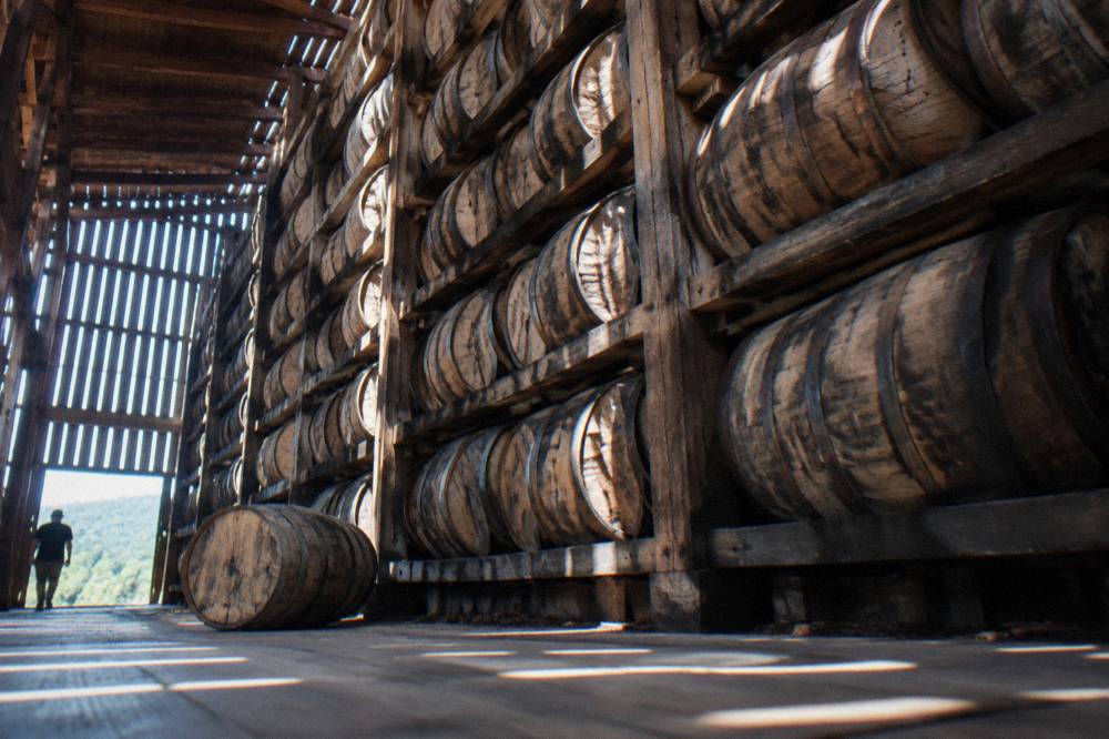Oak bourbon barrels stacked in a Kentucky rackhouse