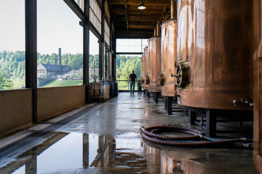 Copper fermentation tanks inside a working Kentucky distillery tour route