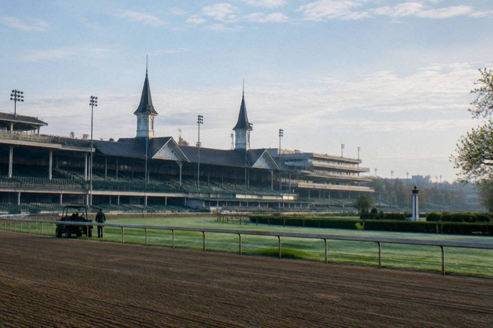 Twin spires rising above a grandstand at a Louisville horse racing track