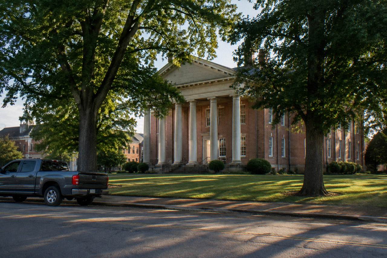 Historic brick courthouse square in Bardstown Kentucky under a late afternoon sky