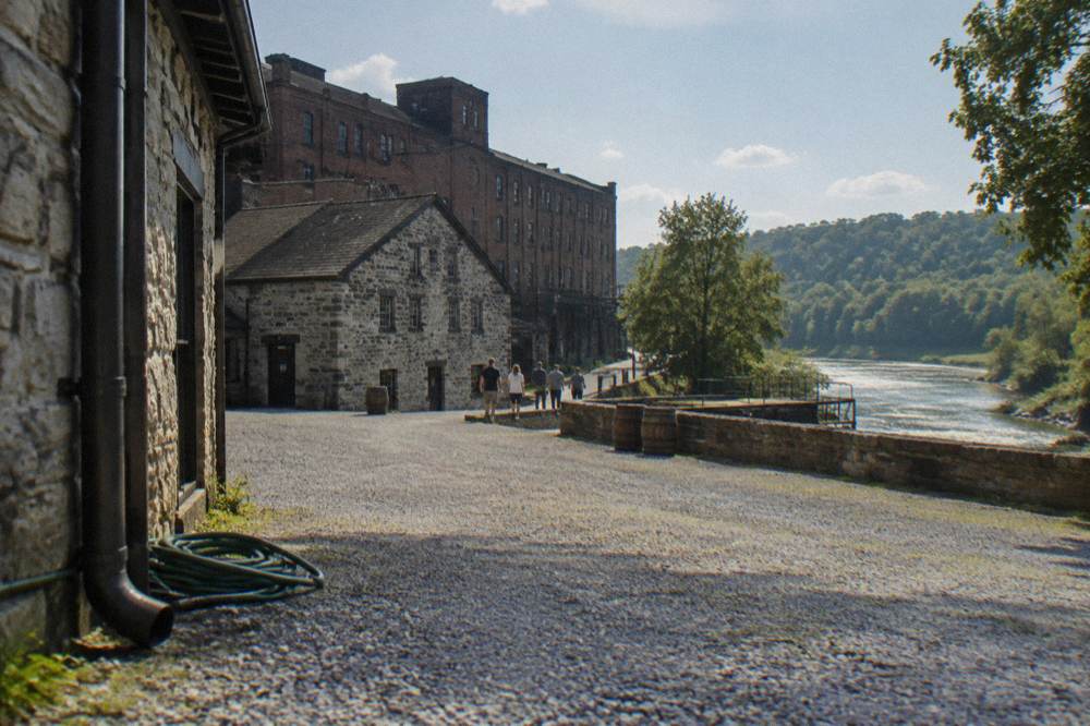 Stone distillery buildings and brick warehouses of Buffalo Trace along the river in Frankfort Kentucky