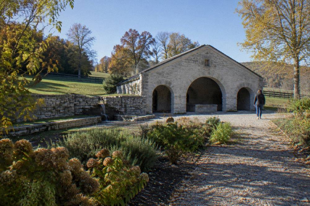 Restored stone springhouse and grounds at a historic Frankfort Kentucky distillery