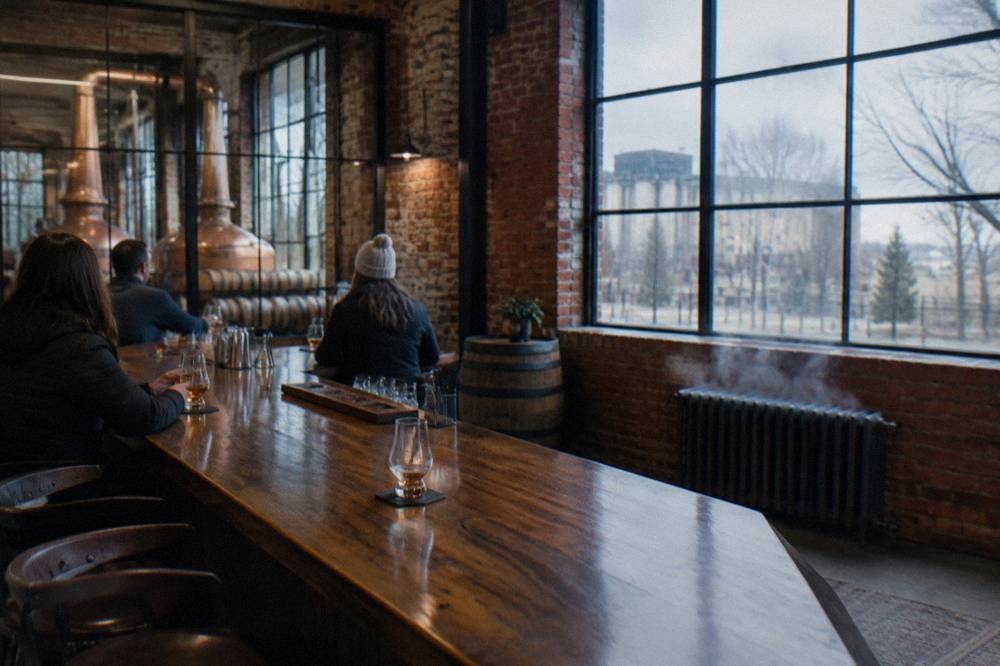 A small group tasting bourbon in glasses at a distillery tasting bar