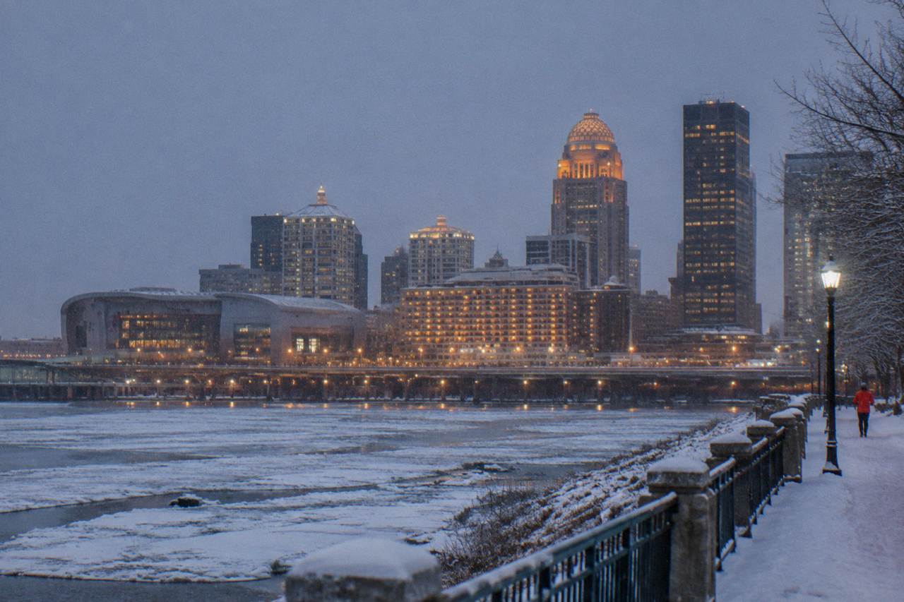 Downtown Louisville skyline at dusk above the Ohio River