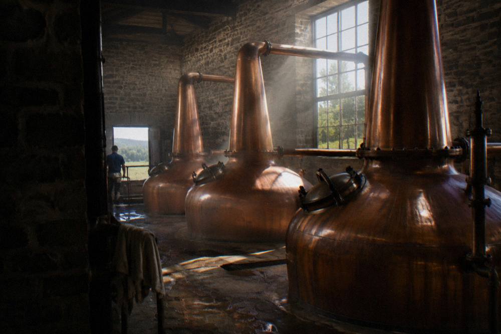 Copper pot stills gleaming inside a historic stone distillery fermenting room